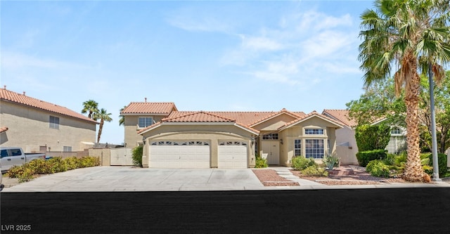 7736 Foredawn Dr, Las Vegas, NV 89123 - mediterranean / spanish home with a tiled roof, stucco siding, an attached garage, and concrete driveway