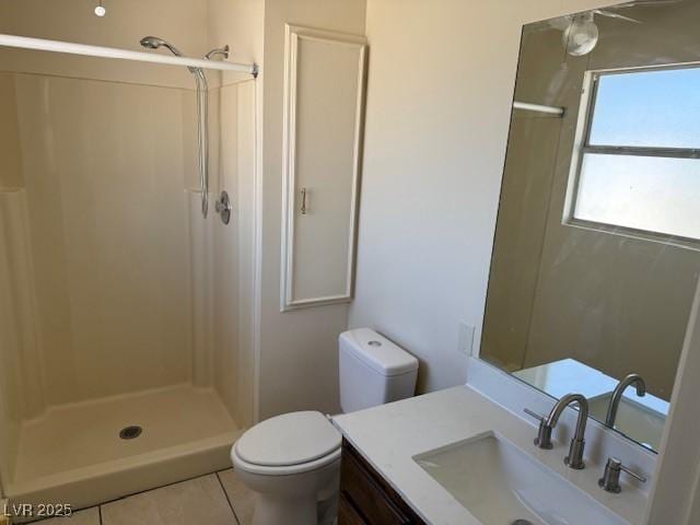 bathroom featuring toilet, a shower stall, and vanity