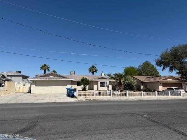 single story home with driveway and an attached garage