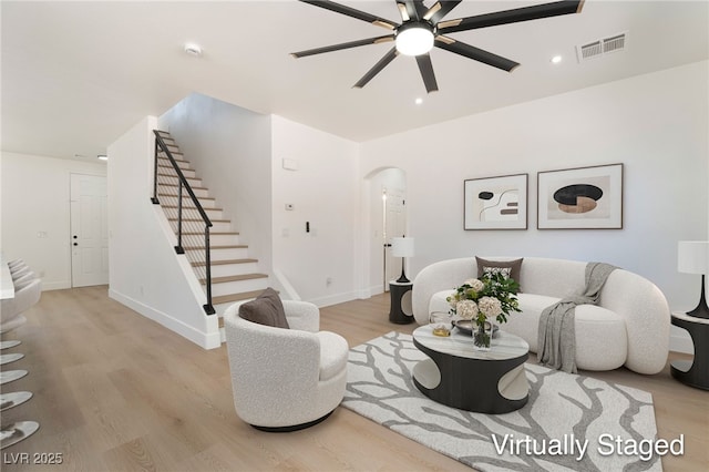 529 Fork Mesa Ct, Henderson, NV 89015 - living area with stairs, ceiling fan, arched walkways, wood finished floors, and baseboards