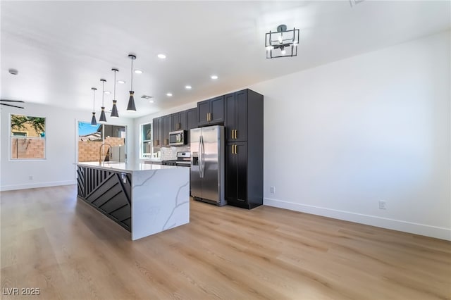 529 Fork Mesa Ct, Henderson, NV 89015 - kitchen with stainless steel appliances, baseboards, light wood-style floors, and recessed lighting