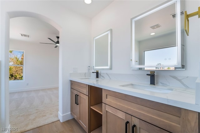 529 Fork Mesa Ct, Henderson, NV 89015 - bathroom with a ceiling fan, double vanity, wood finished floors, baseboards, and recessed lighting