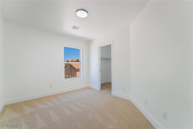 529 Fork Mesa Ct, Henderson, NV 89015 - unfurnished bedroom featuring baseboards, light carpet, a spacious closet, and a closet