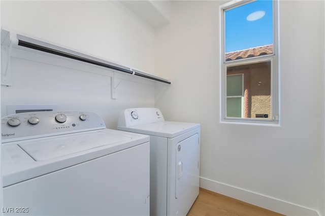 529 Fork Mesa Ct, Henderson, NV 89015 - laundry room with washer and clothes dryer, light wood-style floors, and baseboards