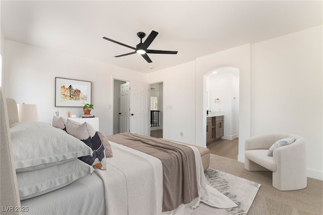 529 Fork Mesa Ct, Henderson, NV 89015 - bedroom with arched walkways, ceiling fan, ensuite bath, and baseboards