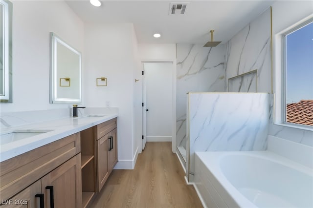 529 Fork Mesa Ct, Henderson, NV 89015 - full bath with wood finished floors, a garden tub, a marble finish shower, double vanity, and recessed lighting