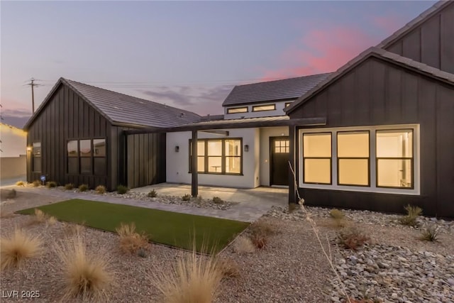 back of house at dusk with board and batten siding
