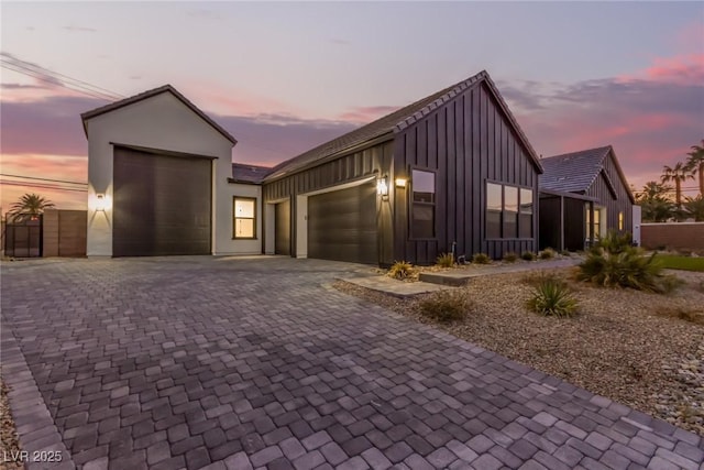 view of front of house featuring board and batten siding, driveway, and an attached garage