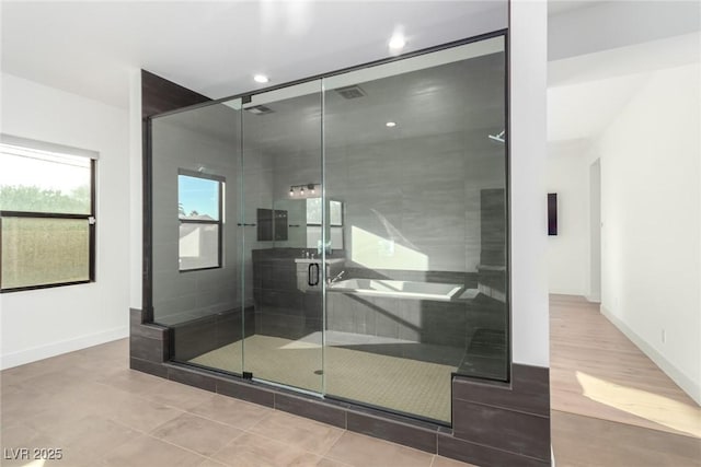 bathroom featuring tile patterned flooring, baseboards, a shower stall, and recessed lighting