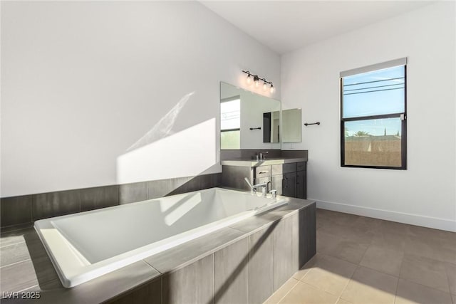 full bathroom with a bath, vanity, tile patterned flooring, and baseboards
