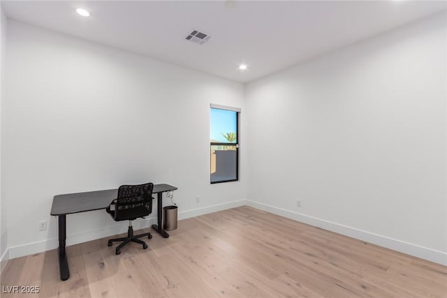 unfurnished office with wood finished floors, recessed lighting, and baseboards