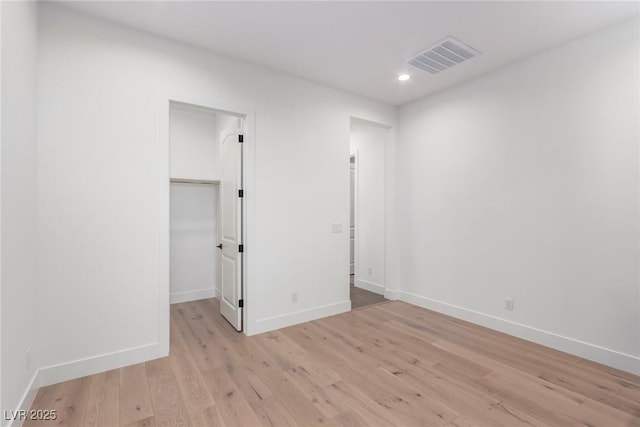 spare room with recessed lighting, light wood-style flooring, and baseboards