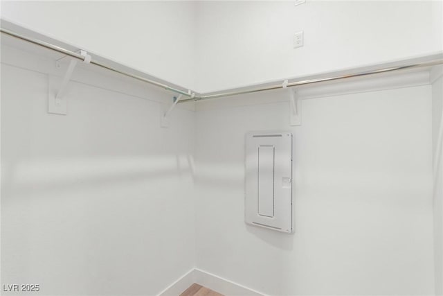 spacious closet featuring wood finished floors and electric panel