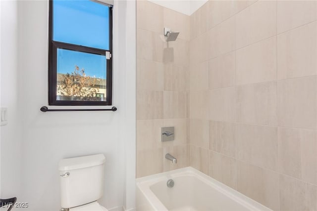 bathroom featuring washtub / shower combination and toilet