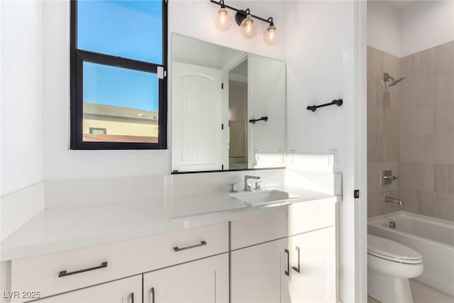 full bath featuring vanity, toilet, and washtub / shower combination