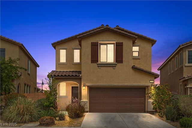 6354 Point Isabel Way, Las Vegas, NV 89122 - view of front of house with a tiled roof, an attached garage, stucco siding, concrete driveway, and fence
