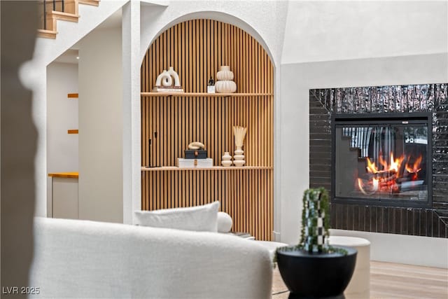 welcome area featuring a glass covered fireplace