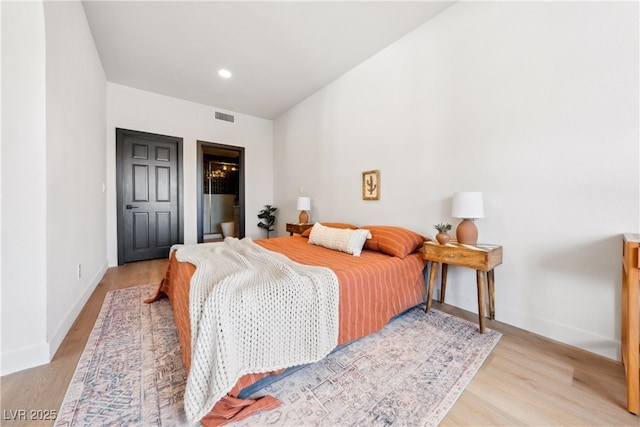 bedroom with light wood-style flooring, baseboards, and recessed lighting