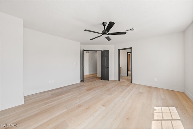 unfurnished bedroom featuring light wood-style floors, baseboards, and ceiling fan
