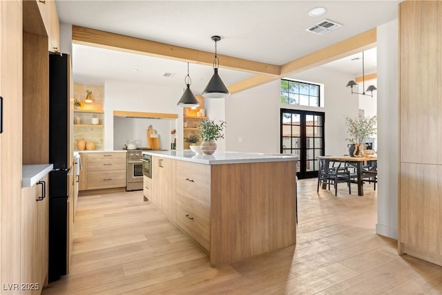 kitchen with light brown cabinets, high end stainless steel range oven, modern cabinets, light wood finished floors, and beamed ceiling