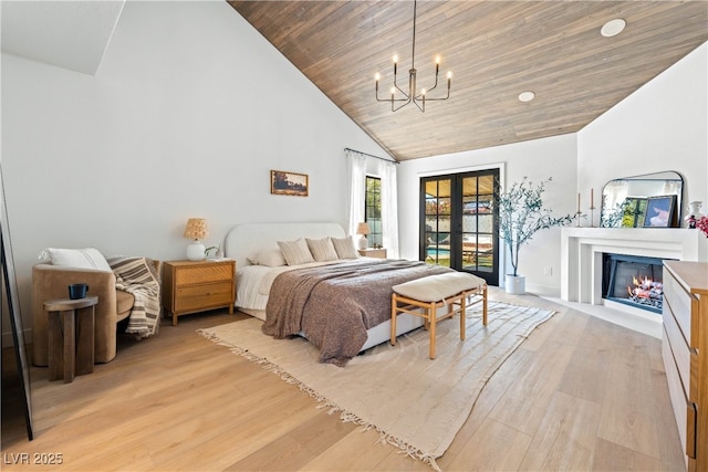 bedroom with high vaulted ceiling, light wood-style flooring, a chandelier, wooden ceiling, and a fireplace with flush hearth