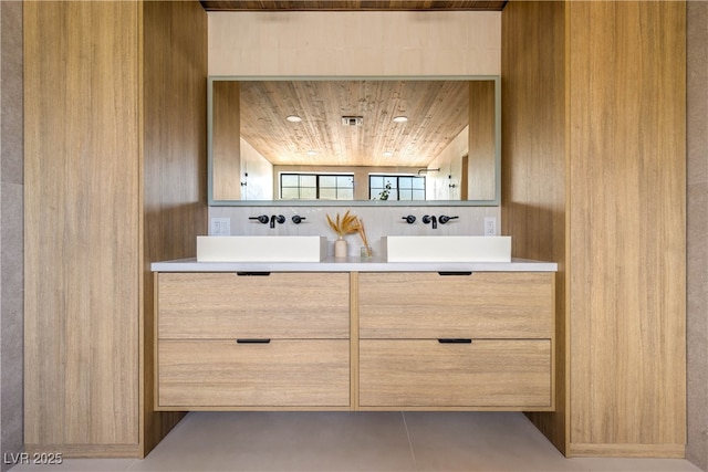 bathroom with double vanity, wooden ceiling, and tile patterned flooring