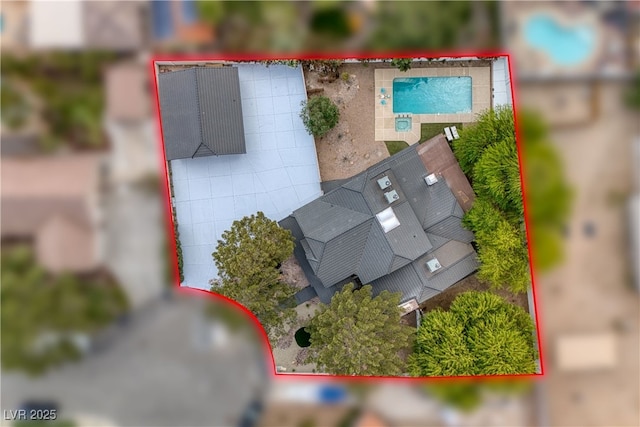 aerial overview of property's location with property boundaries highlighted and a pool