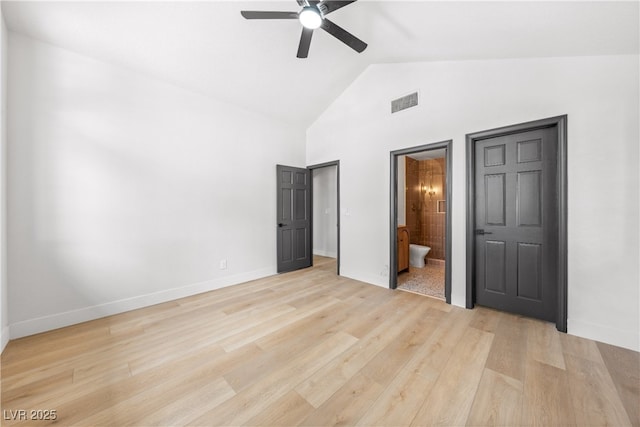 unfurnished bedroom with light wood-style flooring, connected bathroom, high vaulted ceiling, baseboards, and a ceiling fan