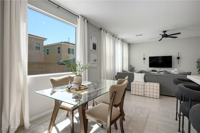 dining space with plenty of natural light and ceiling fan