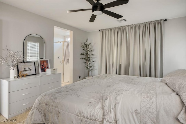 bedroom featuring a ceiling fan and ensuite bath