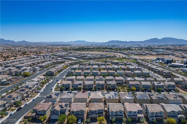 view of property location featuring a mountainous background and nearby suburban area