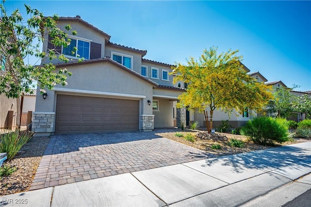 view of front of home featuring stone siding, stucco siding, decorative driveway, and a tile roof