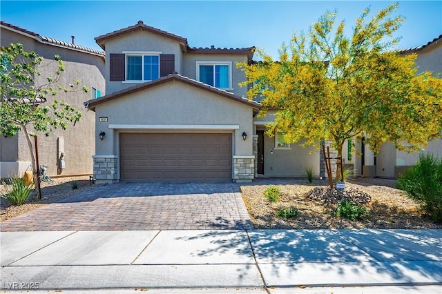 view of front of property with stucco siding, decorative driveway, and stone siding