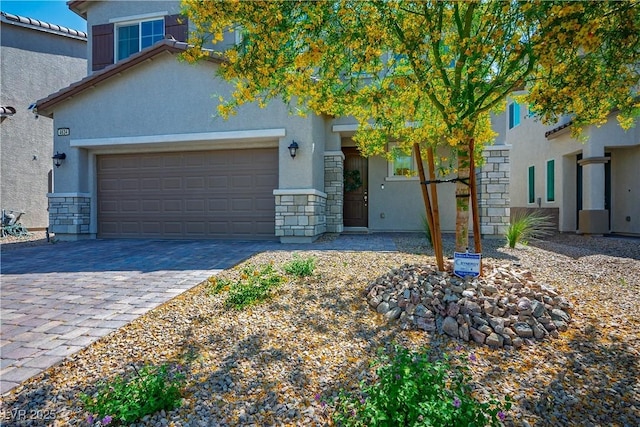 view of front of home with stone siding, stucco siding, decorative driveway, and an attached garage