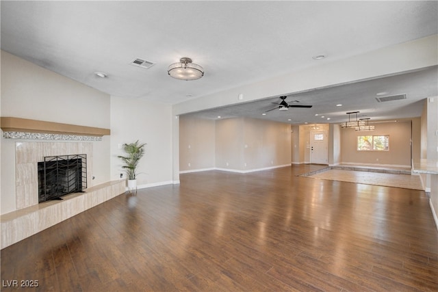 6117 Foxcroft Ave, Las Vegas, NV 89108 - unfurnished living room with ceiling fan, a tile fireplace, wood finished floors, baseboards, and recessed lighting