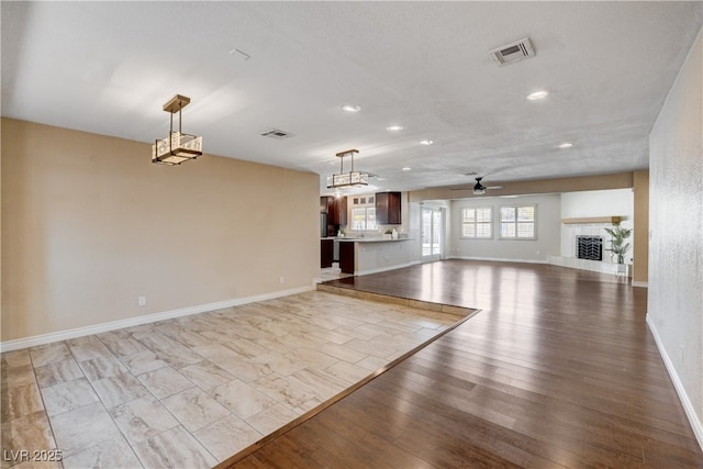 6117 Foxcroft Ave, Las Vegas, NV 89108 - unfurnished living room with recessed lighting, baseboards, ceiling fan, light wood finished floors, and a fireplace with raised hearth