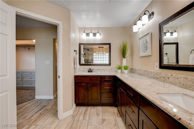 6117 Foxcroft Ave, Las Vegas, NV 89108 - full bathroom with double vanity, a shower, and a spacious closet