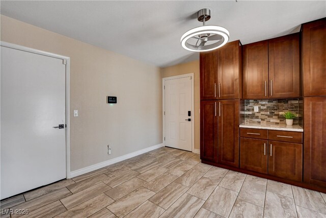 6117 Foxcroft Ave, Las Vegas, NV 89108 - kitchen featuring tasteful backsplash, light countertops, and baseboards
