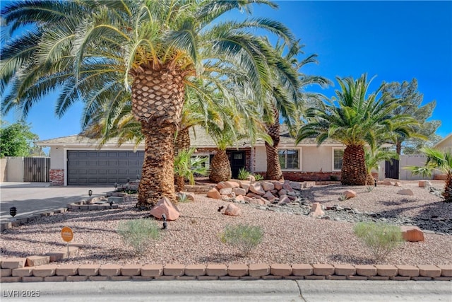 6117 Foxcroft Ave, Las Vegas, NV 89108 - view of property hidden behind natural elements featuring concrete driveway, an attached garage, fence, and brick siding