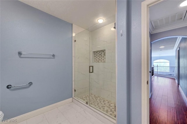 full bath with baseboards, a stall shower, toilet, and marble look tiles