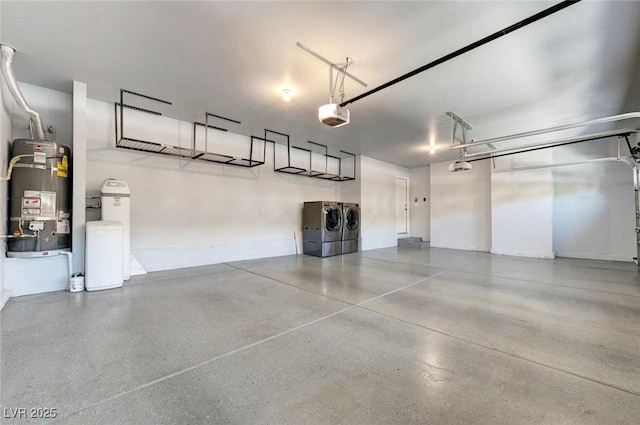 garage with secured water heater, washing machine and clothes dryer, and a garage door opener