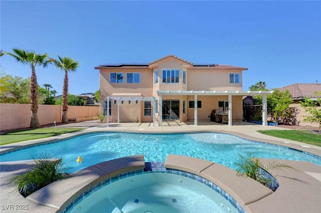 view of pool with a fenced backyard, a patio, a pool with connected hot tub, and a pergola