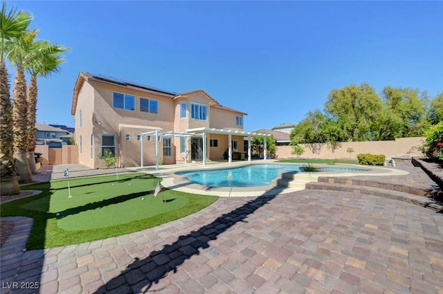 view of swimming pool with a putting area, an in-ground hot tub, a pergola, a patio area, and a fenced backyard