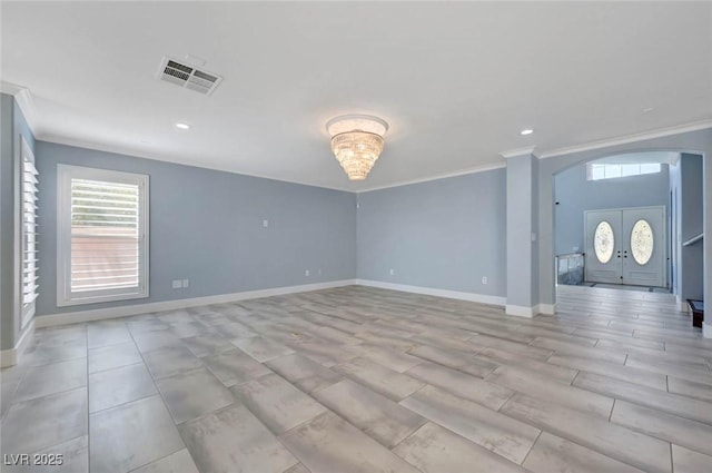 unfurnished living room featuring arched walkways, ornamental molding, baseboards, and recessed lighting