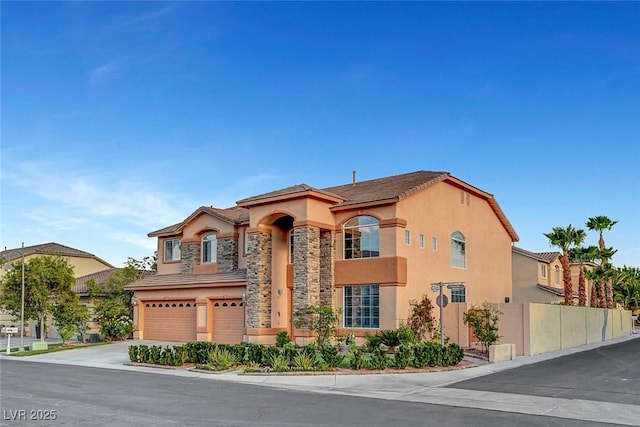 281 Powerbilt Ave, Las Vegas, NV 89148 - view of building exterior featuring an attached garage, fence, and driveway