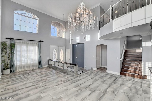 281 Powerbilt Ave, Las Vegas, NV 89148 - entryway featuring arched walkways, a high ceiling, ornamental molding, stairway, and a chandelier