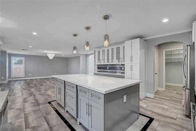 281 Powerbilt Ave, Las Vegas, NV 89148 - kitchen featuring crown molding, baseboards, recessed lighting, arched walkways, and gray cabinetry