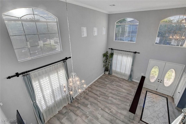 281 Powerbilt Ave, Las Vegas, NV 89148 - foyer entrance with a chandelier, crown molding, baseboards, wood finished floors, and a high ceiling