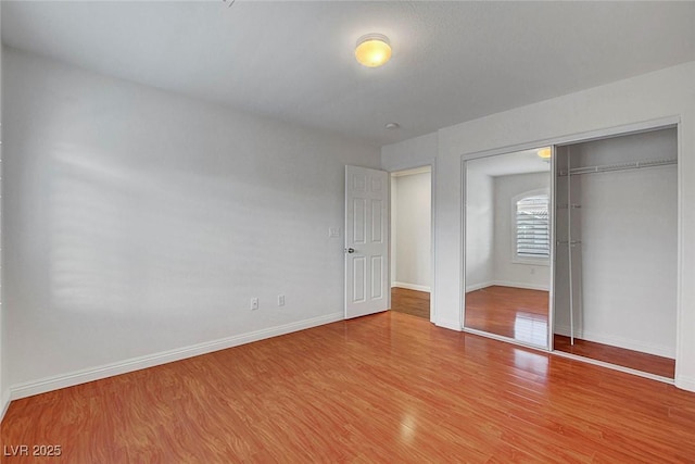 281 Powerbilt Ave, Las Vegas, NV 89148 - unfurnished bedroom with wood finished floors, baseboards, and a closet