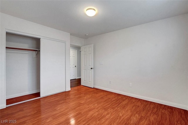 281 Powerbilt Ave, Las Vegas, NV 89148 - unfurnished bedroom featuring wood finished floors, baseboards, and a closet